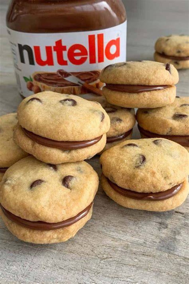 Cookie split open with Nutella filling inside.