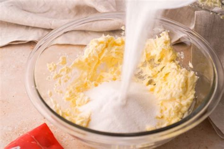 Flour, butter, sugar in a glass mixing bowl.