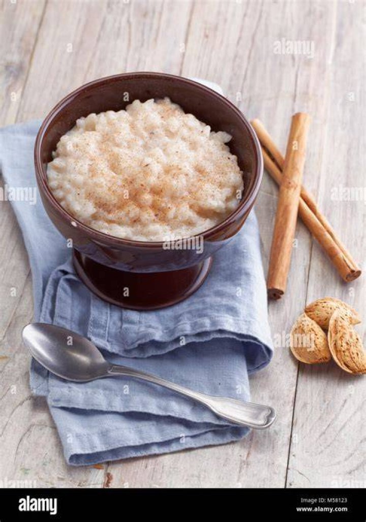 Rice pudding topped with cinnamon in a white bowl.